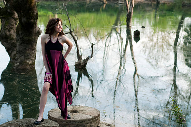 istock Young Woman Standing Outdoors in Green Park 182755453