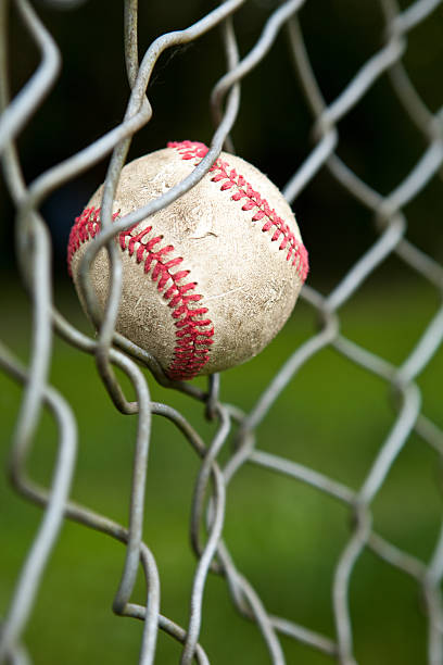 istock Baseball caught in a chain link fence. 182755944