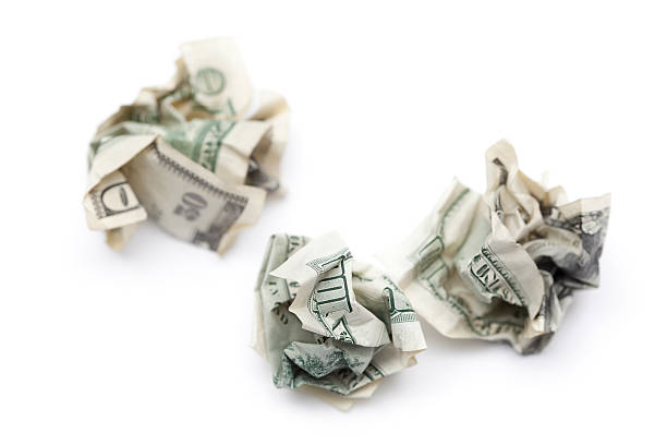 istock Wadded up Currency - Crumpled Money as Garbage 182755999