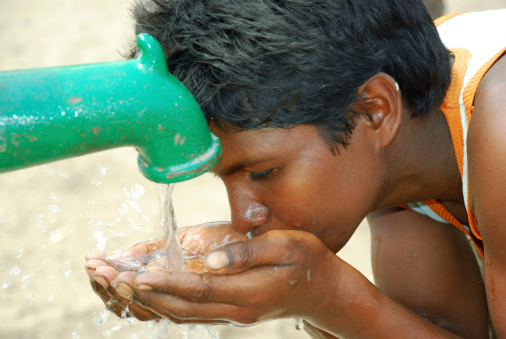 Rural boy Drinking tap water..