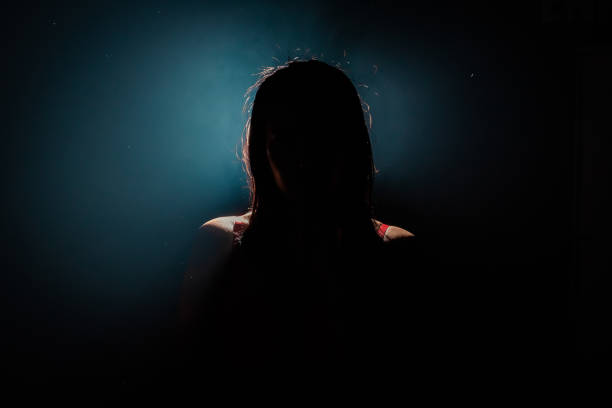 istock unrecognizable woman silhouette on black background 1827567828
