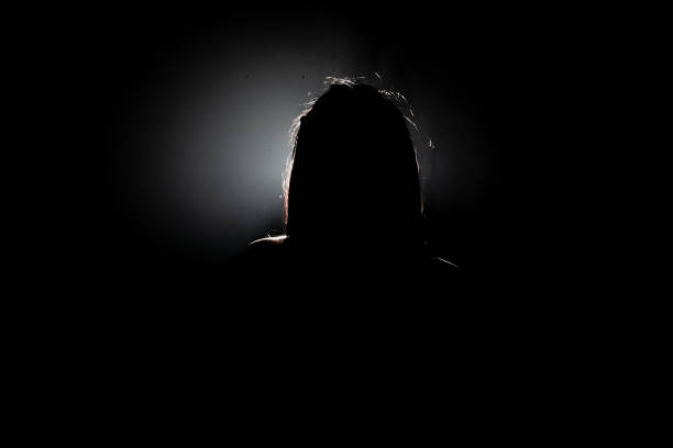 istock woman silhouette on black background 1827568349