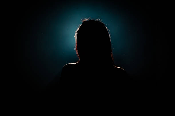 istock unrecognizable woman head silhouette on black background 1827568902