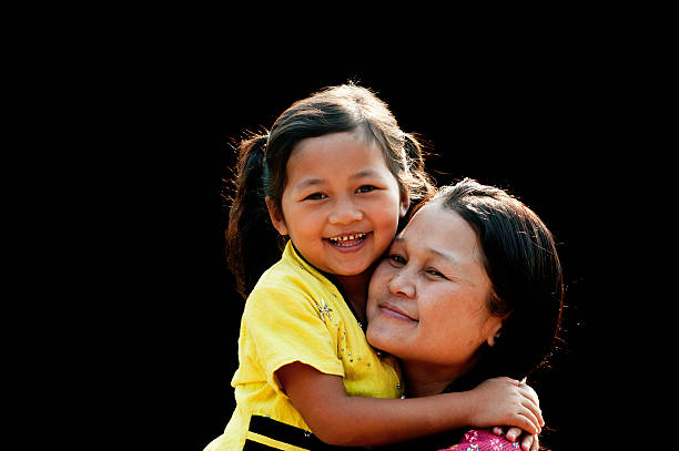 Po Karen Mother and Child Po Karen mother and daughter having fun in a northern Thai village. Shot using avaiable light. padaung tribe stock pictures, royalty-free photos & images