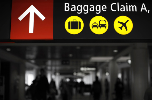 Baggage Claim Sign at Airport. Part of Image Desaturated to Black and White