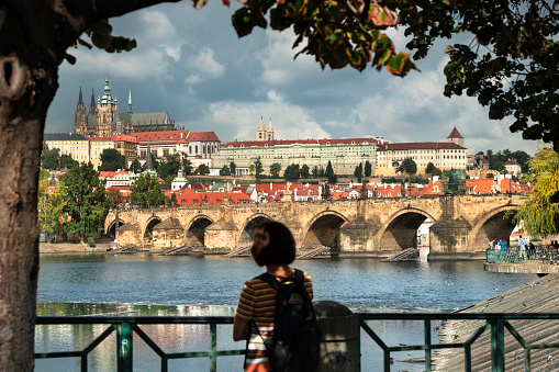 Vltava river with historic bridges of Prague at the golden hour photographed from Letna park. Long exposure.