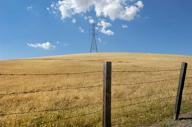 istock Pylons, Power Lines, Clouds and Barbed Wire Fence 182757522