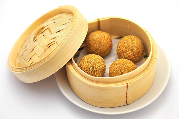 Sesame balls "Sesame balls in Chinese bamboo basket,Related images:" red bean dessert stock pictures, royalty-free photos & images