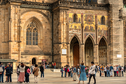Prague, Czechia - September 13, 2022:  People gather in the courtyard by the St. Vitus Cathedral church in the Prague Castle complex Czech Republic Czechia Europe