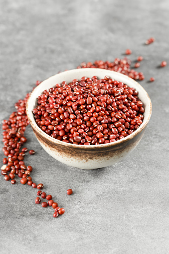 Red adzuki beans on black background plate