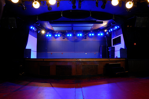 An empty stage at a small, trendy venue.