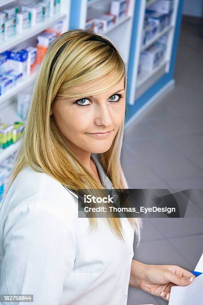 Pharmacy Technician Holding A Prescription Stock Photo - Download Image Now - 20-29 Years, Adult, Adults Only