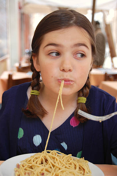 istock Young girl enjoying spaghetti carbonara 182758892