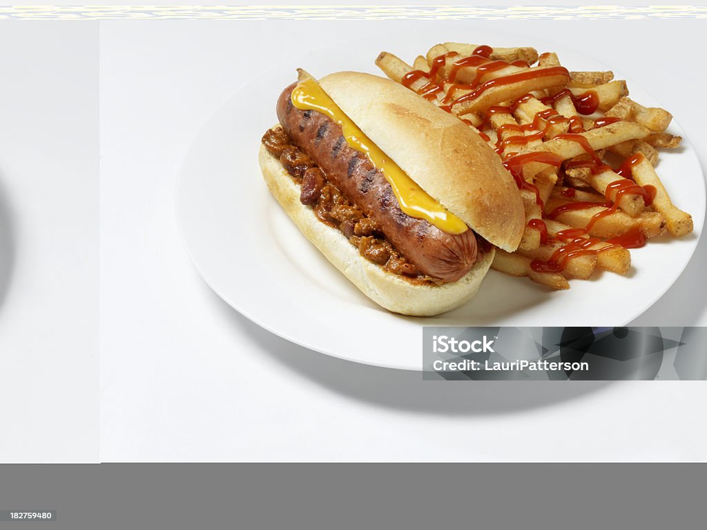 Chili Cheese Dog with Fries Hot Dog, Smokie with Chili, Cheese Sauce and French Fries- Photographed on Hasselblad H3D2-39mb Camera Chili Dog Stock Photo