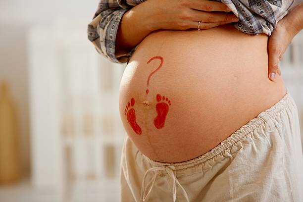 istock Pregnant belly with little footprints 182759653