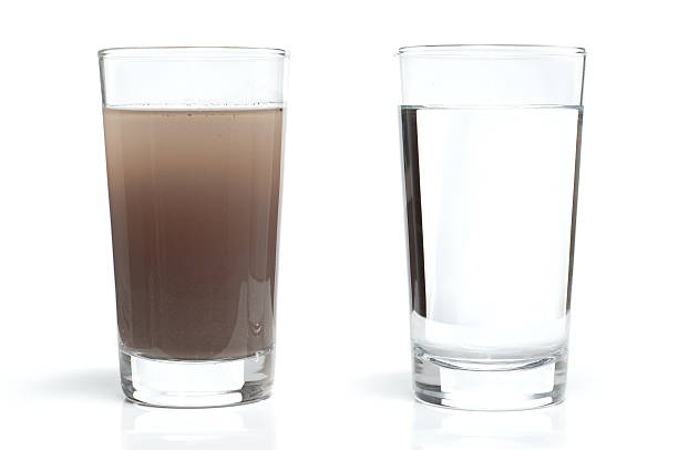 Dirty and Clean Water in Glasses Two water glasses. One with dirty water and the other with fresh, clean water. glass of water stock pictures, royalty-free photos & images