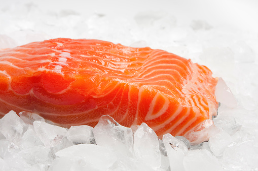 A fillet of salmon on ice and ready for the pan, grill, or broiler.