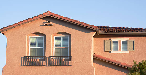 Stucco home exterior glowing in the early morning sunlight.  Typical Southern California architectural style.