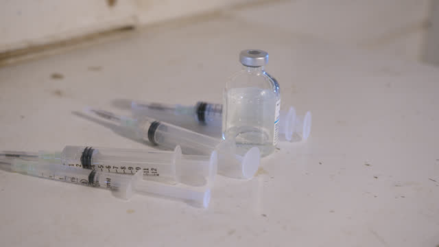 Hypodermic Syringes and a Glass Vaccine Vial Container at an Animal Hospital