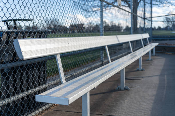 istock An empty aluminum bench in a baseball dugout 1827609409