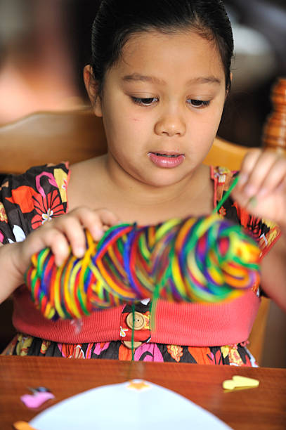 色で遊ぶ少女 - schoolgirl little girls crayon human face ストックフォトと画像