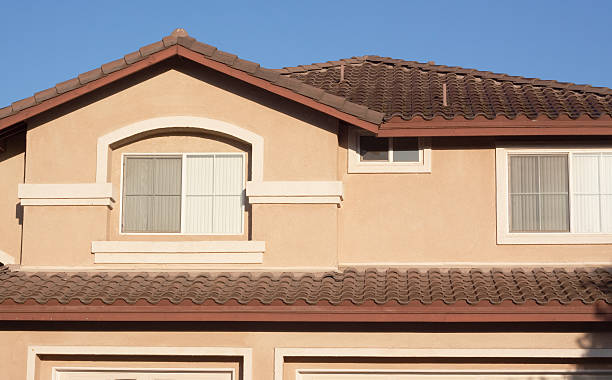istock Cream Colored Stucco Home Exterior and  Blue Sky 182761332