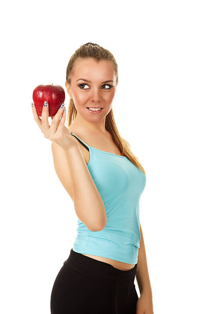 istock fitness girl holding apple 182761342