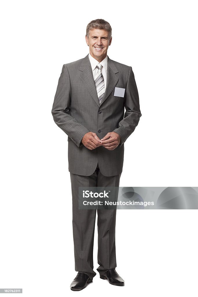 Uomo d'affari sorridente con etichetta nome vuoto - Foto stock royalty-free di Abbigliamento da lavoro