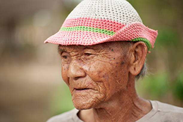 Senior Po Karen man wearing a hat.