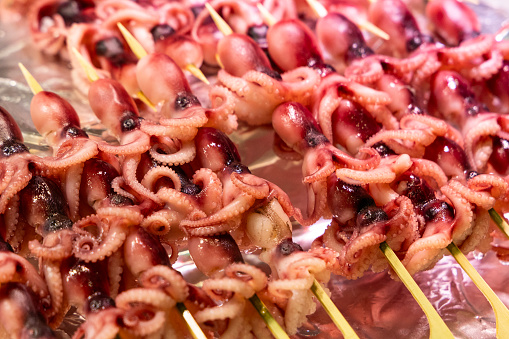 A close-up of delicious grilled octopus skewers.