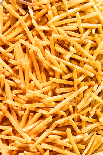 A macro shot of a pile of french fries filling the entire frame.