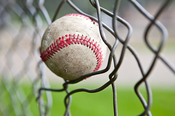 istock Baseball stuck in a chain link fence. 182763321