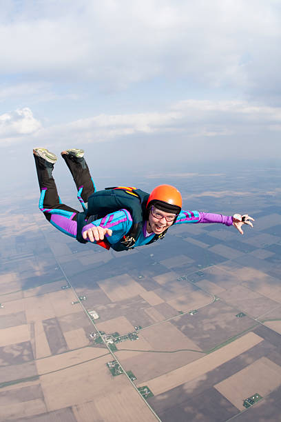 foto stock royalty-free: felice donna skydiving - freefall foto e immagini stock