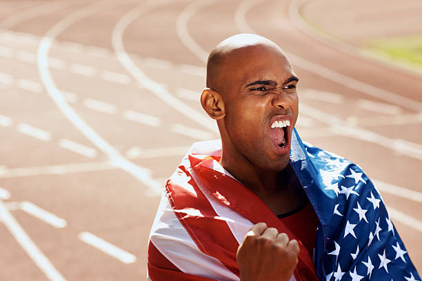 istock Man cheering with American flag around his shoulders 182764197