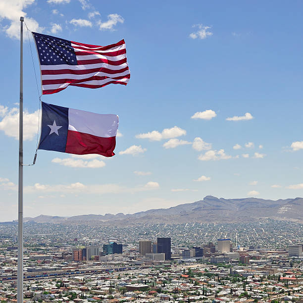 Downtown El Paso "A shot of downtown El Paso, Texas, with the U.S. and Texas flags in the foreground.  Ciudad Juarez and the Juarez Mountains of northern Mexico are visible to the south of the downtown.  This picture was taken from a point just up the hill from El Paso's famous Scenic Drive." el paso texas photos stock pictures, royalty-free photos & images