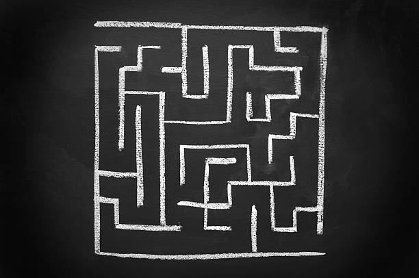 istock A labyrinth design in white set against a black background 182764438