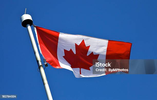 Canadian Flag Waving In A Blue Sky Stock Photo - Download Image Now - Blue, Canada, Canada Day