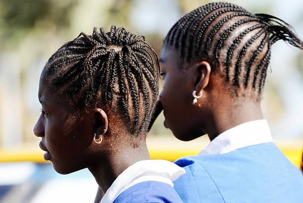 Two young african school girls with braided hair stock photo