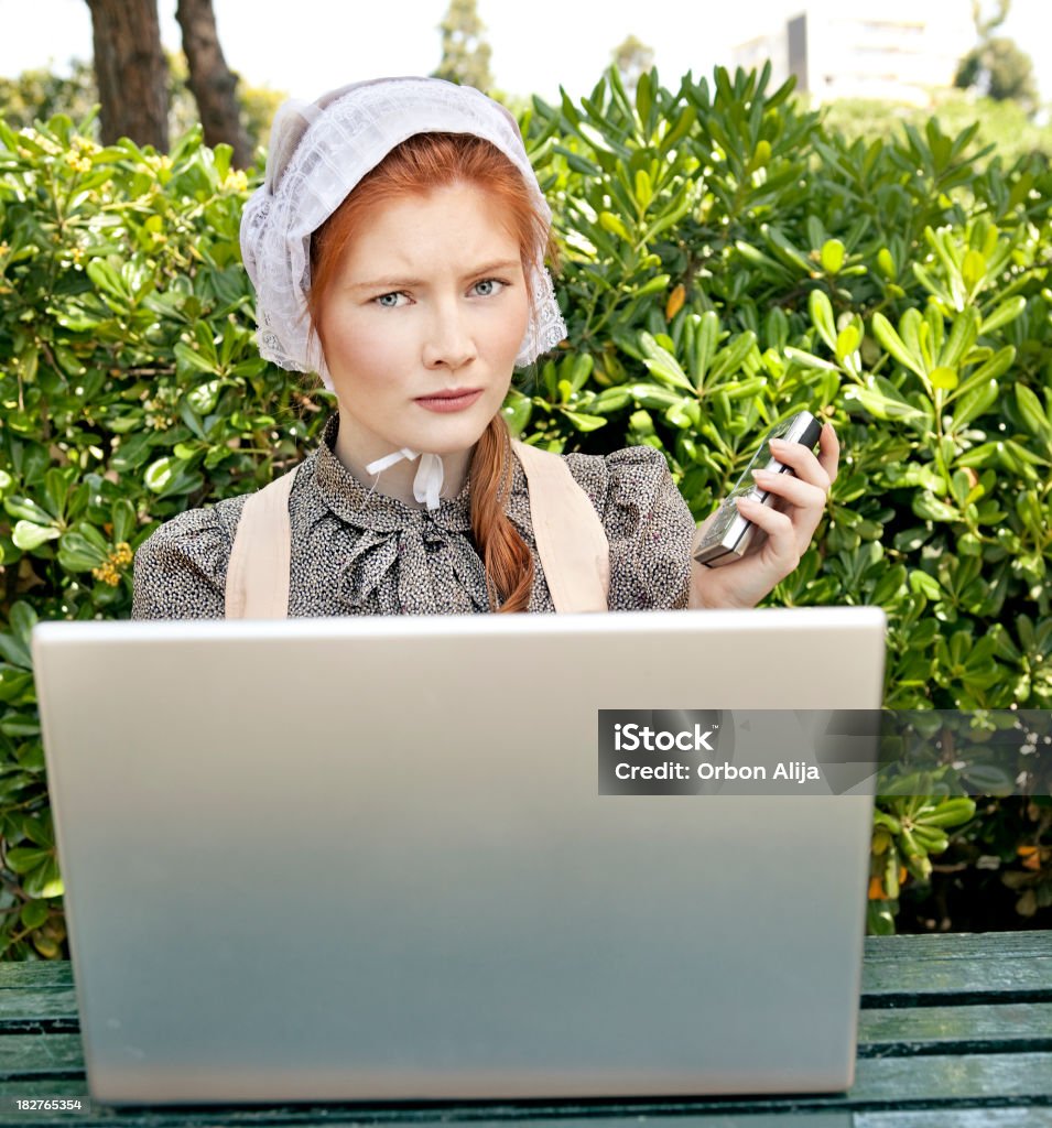 Rural life Amish woman using a laptop for the first time Color Image Stock Photo