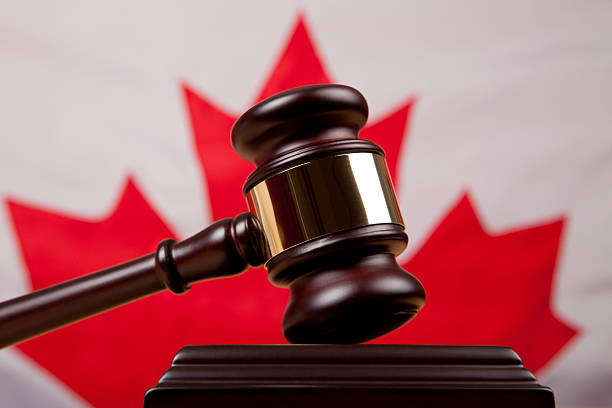 Gavel in front of Canadian flag representing Canadian legal and justice system.