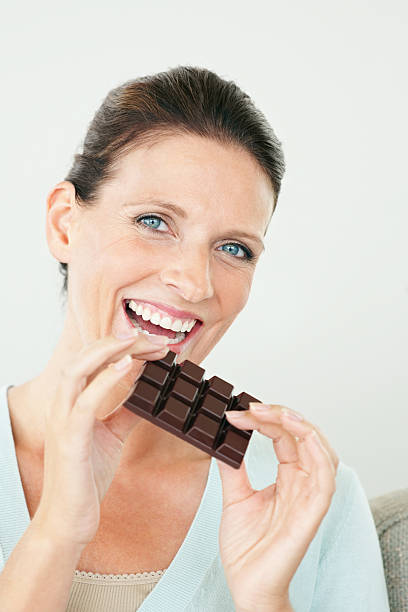 istock Pretty woman eating dark chocolate on white 182766745