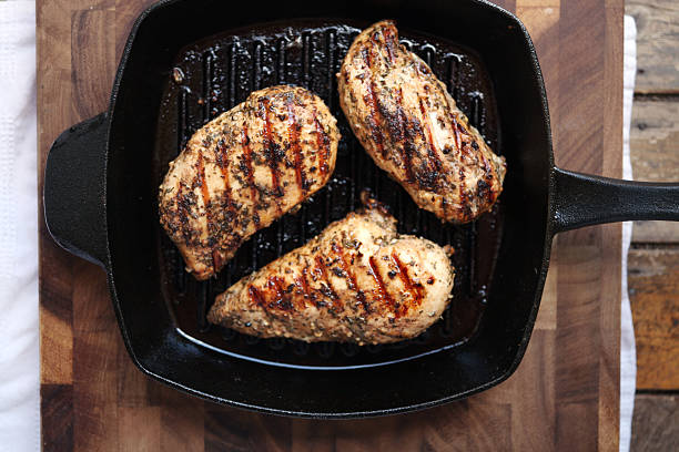 Grilled chicken breasts "Healthy eating: grilled skinless, boneless chicken breasts in a cast iron grilling pan." Boneless Skinless Chicken Breast stock pictures, royalty-free photos & images