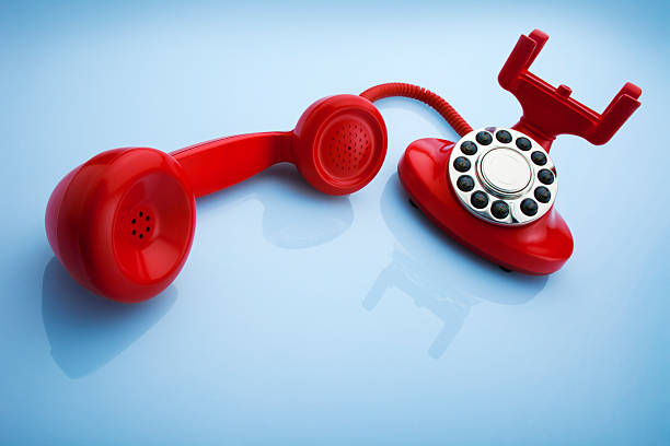istock Red Old Fashioned Telephone on a Blue Background 182766852