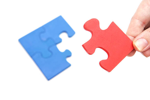istock Adding a Red piece to the Blue puzzle. 182766858