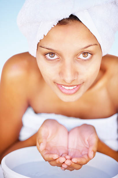 istock Smiling young female washing face at a basin 182766944