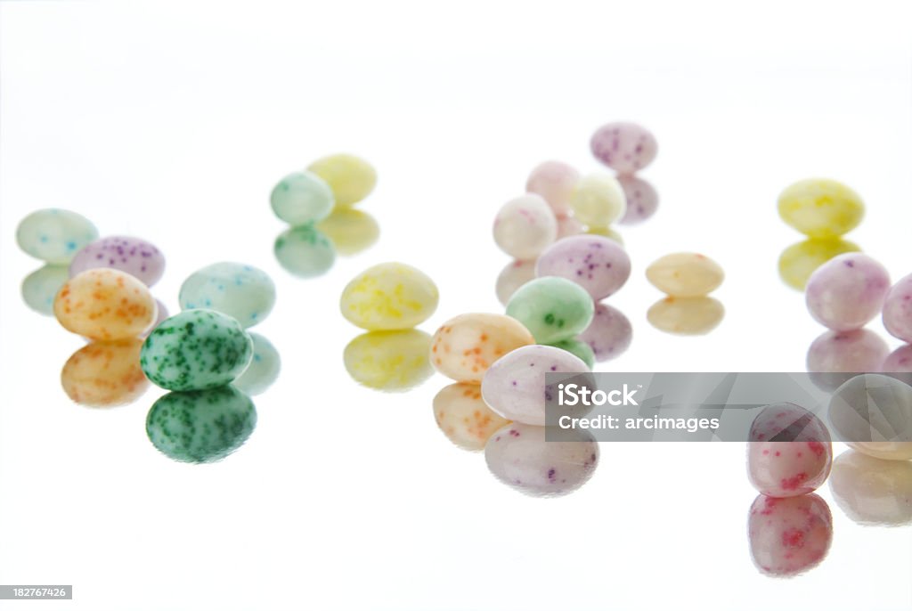 speckled jelly beans on reflective surface Candy Stock Photo