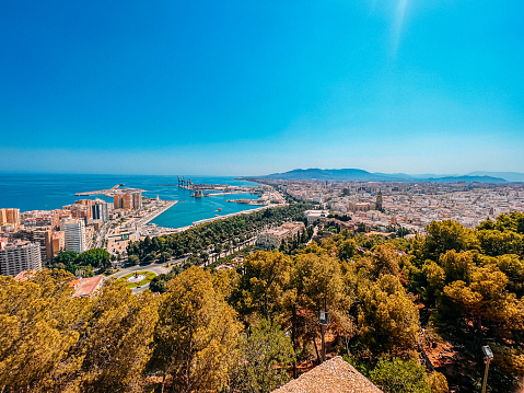 Málaga Park, Jardines de Pedro Luis Alonso, Fuente de las Tres Gracias, and Port of Malaga, Spain on a Hazy Day in the Summer