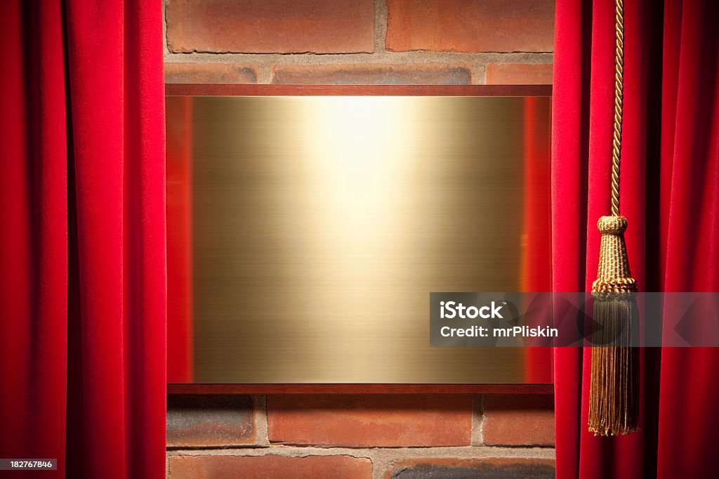 Red velvet curtain reveals blank brass plaque Red velvet curtain reveals blank brass plaque ready to take your message. Curtain Stock Photo