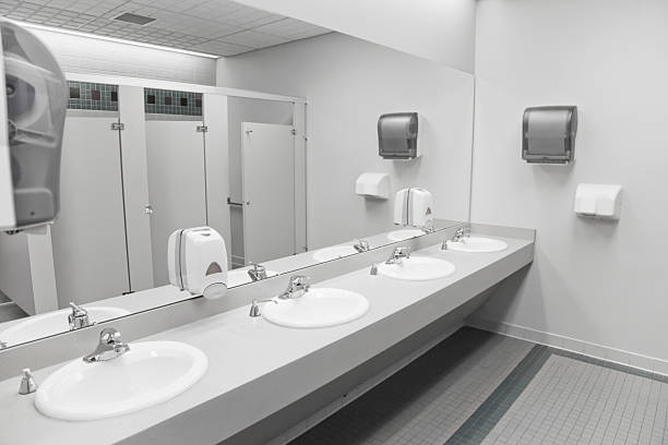 An empty commercial/public restroom A public restroom's sinks. paper towel photos stock pictures, royalty-free photos & images
