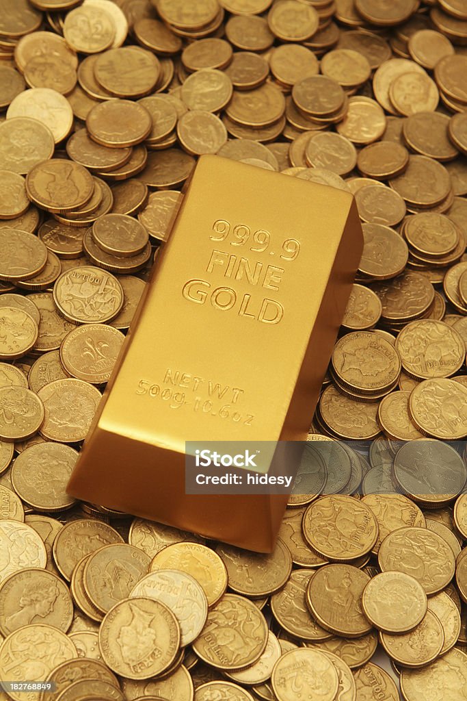 Gold Ingot on Coins gold ingot on gold coins Australian Currency Stock Photo